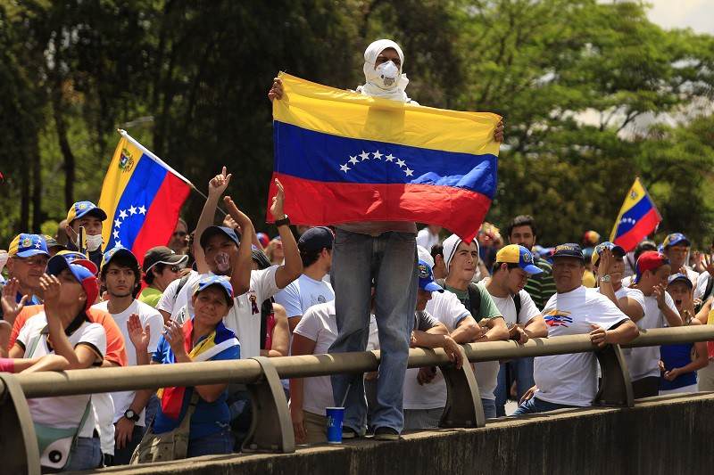 Anti-government protesters march during a protest in Caracas