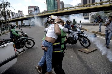 ¡FOTO DE LA SEMANA! Miembro del cuerpo de rescate socorre a un niño, víctima de lacrimógenas