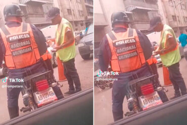 “Ahora entiendo porqué continúan”: difunden video en el que se observa a un “cuida carros” dar dinero a un oficial de la PNB en Caracas (+Video)